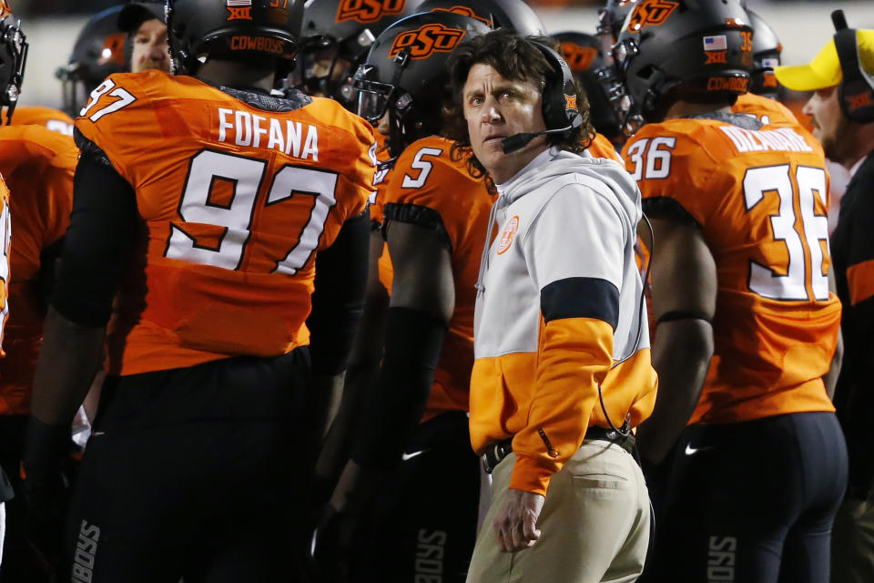 Oklahoma State head coach Mike Gundy looks up at the scoreboard during a timeout in an NCAA college football game against Oklahoma in Stillwater, Okla., Saturday, Nov. 30, 2019. (AP Photo/Sue Ogrocki)