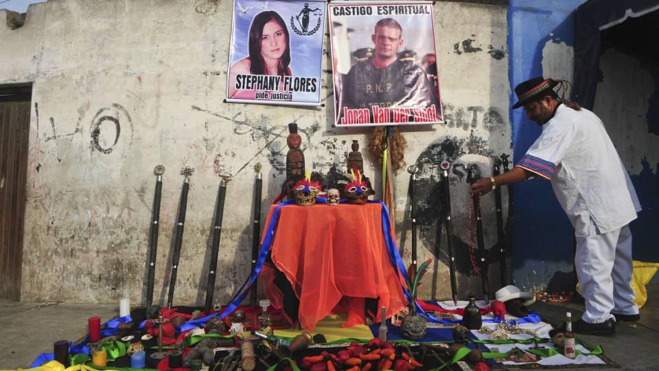 a shaman ceremony takes place in front of posters of joran van der sloot and stephany flores