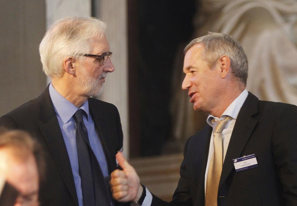 Brian Cookson, of Britain, left, and Igor Makarov, after being elected president of the UCI, International Cycling Union, in Florence, Friday, Sept. 27, 2013. (AP Photo/Fabrizio Giovannozzi)