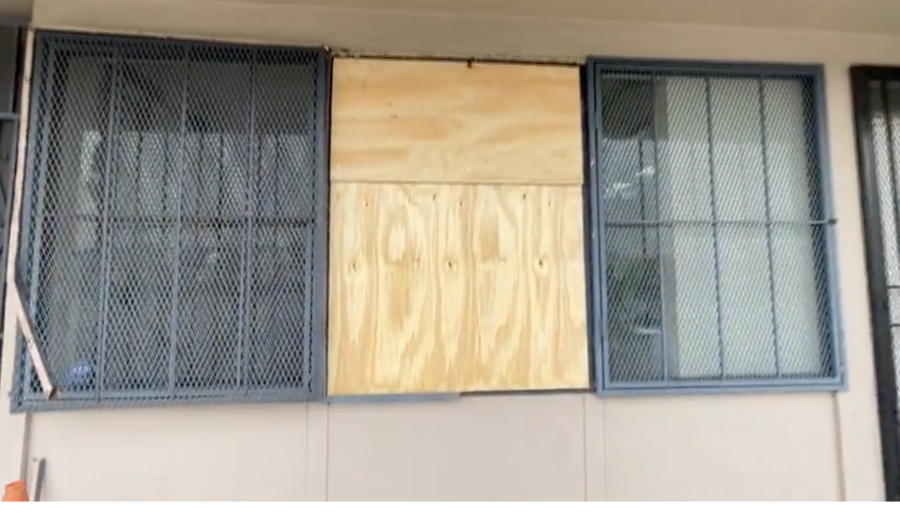 The window the burglars used to rob Vista Pharmacy is boarded up on Feb. 25, 2024 (KTLA)