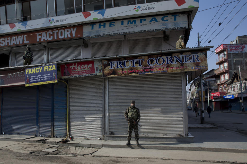 Indian paramilitary soldiers stand guard outside a closed market during a strike in Srinagar, Indian controlled Kashmir, Thursday, Feb. 28, 2019. As tensions escalate between India and Pakistan, shops and business remained closed for the second consecutive day in Indian portion of Kashmir following a strike call by separatist leaders to protest Tuesday's raids on key separatist leaders by Indian intelligence officers. (AP Photo/ Dar Yasin)