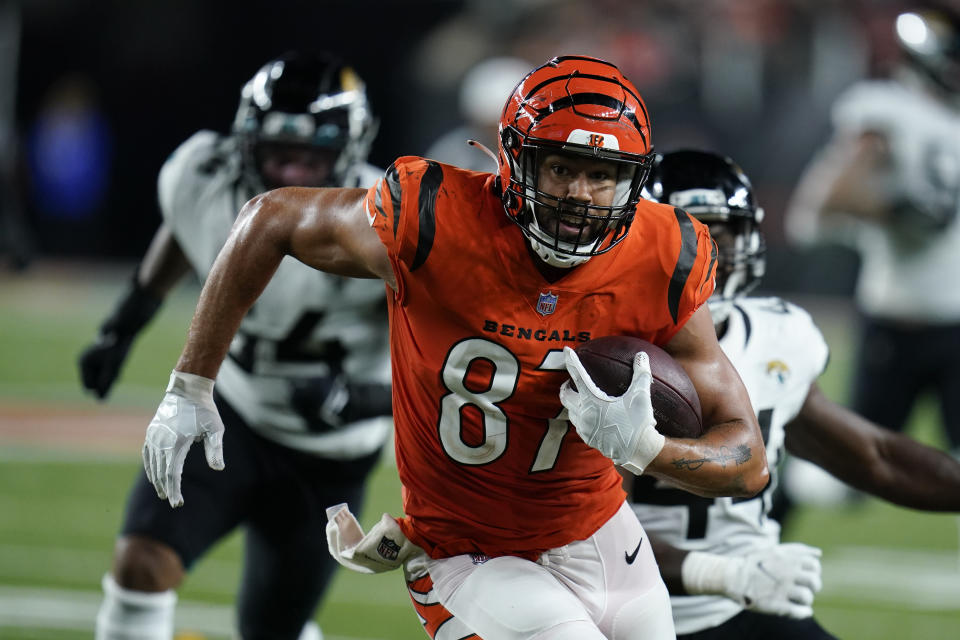 Cincinnati Bengals' C.J. Uzomah (87) goes in for a touchdown during the second half of an NFL football game against the Jacksonville Jaguars, Thursday, Sept. 30, 2021, in Cincinnati. (AP Photo/Michael Conroy)