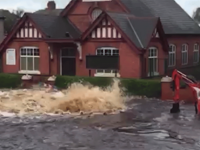 Residential street completely submerged in water after mains pipe bursts