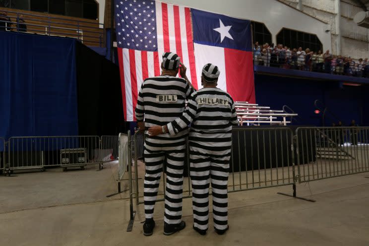 Trump supporters costumed as Bill and Hillary Clinton in prison uniforms sing the national anthem before a rally for Donald Trump in Austin, Texas, on Tuesday. (Carlo Allegri/Reuters)