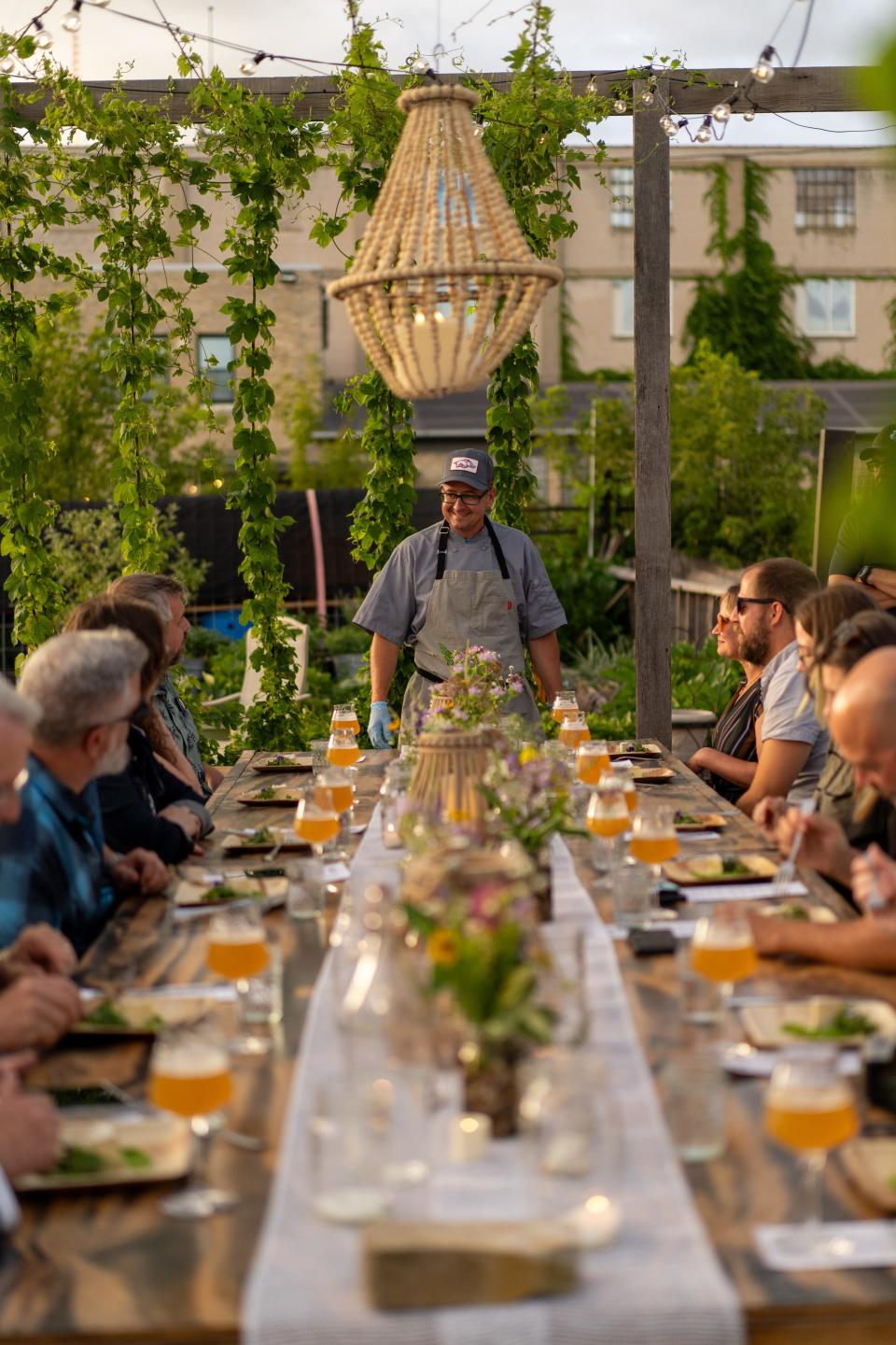 Joel Lichosik introduces one of the courses to guests at Crops on Top's monthly five-course dinner event. Joel uses his decades of culinary experience to create a menu from the farm's crops one week before each dinner is held.