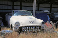 <p>Some of the rarer vehicles have been kept undercover, like this desirable 1953 DeSoto Firedome V8 convertible. It’s one of just 1700 built, and it’s looking for a new home. </p><p>Incredibly, the car was driven into the shed some 30 years ago, having covered just 70,897 miles. It is solid, rust-free, and other than a few missing bits of trim, is pretty much complete. This particular barn find has an ambitious $16,000 price tag.</p>