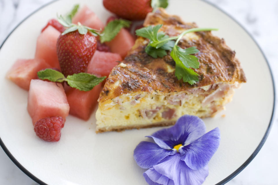 In this image taken on April 22, 2013, a slice of ham and cheddar quiche for Mother's Day is shown served on a plate in Concord, N.H. (AP Photo/Matthew Mead)