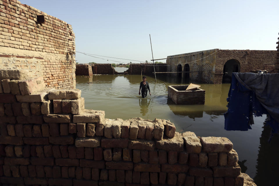 A boy wades through floodwaters from monsoon rains, in Jaffarabad, Pakistan, Monday, Sept. 5, 2022. The U.N. refugee agency rushed in more desperately needed aid Monday to flood-stricken Pakistan as the nation's prime minister traveled to the south where rising waters of Lake Manchar pose a new threat. (AP Photo/Fareed Khan)