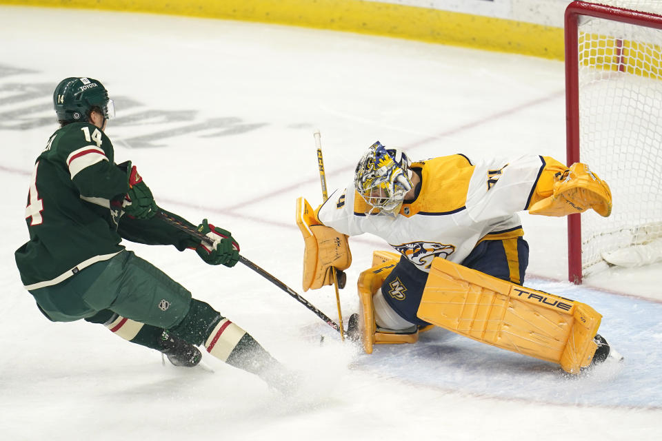 Nashville Predators goaltender Juuse Saros, right, blocks a shot-attempt by Minnesota Wild center Joel Eriksson Ek, left, during the first period of an NHL hockey game Sunday, Feb. 19, 2023, in St. Paul, Minn. (AP Photo/Abbie Parr)