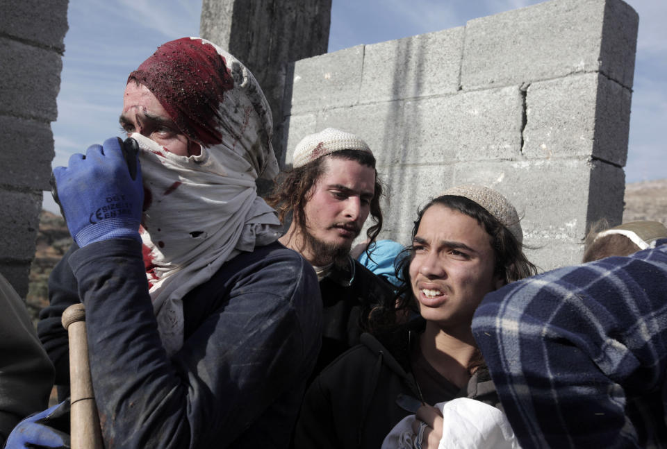 Israeli settlers are cornered as Palestinians detained and beat them at a construction site in the West Bank, January 7, 2014. (JAAFAR ASHTIYEH/AFP/Getty Images)