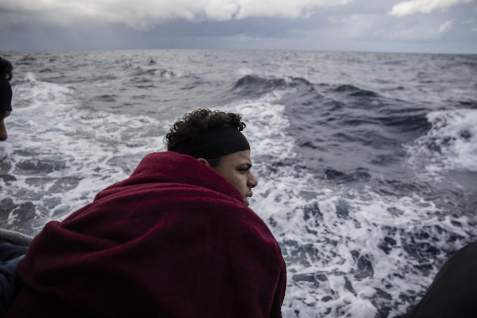 In this Monday Jan. 13, 2020 photo, a Moroccan boy watches the sea on board the Spanish NGO Open Arms vessel, as the NGO waits for the authorities to allow them to enter in the nearest safe port with the 118 people who were rescued off the Libyan coast on Friday, international waters, Central Mediterranean sea. (AP Photo/Santi Palacios)