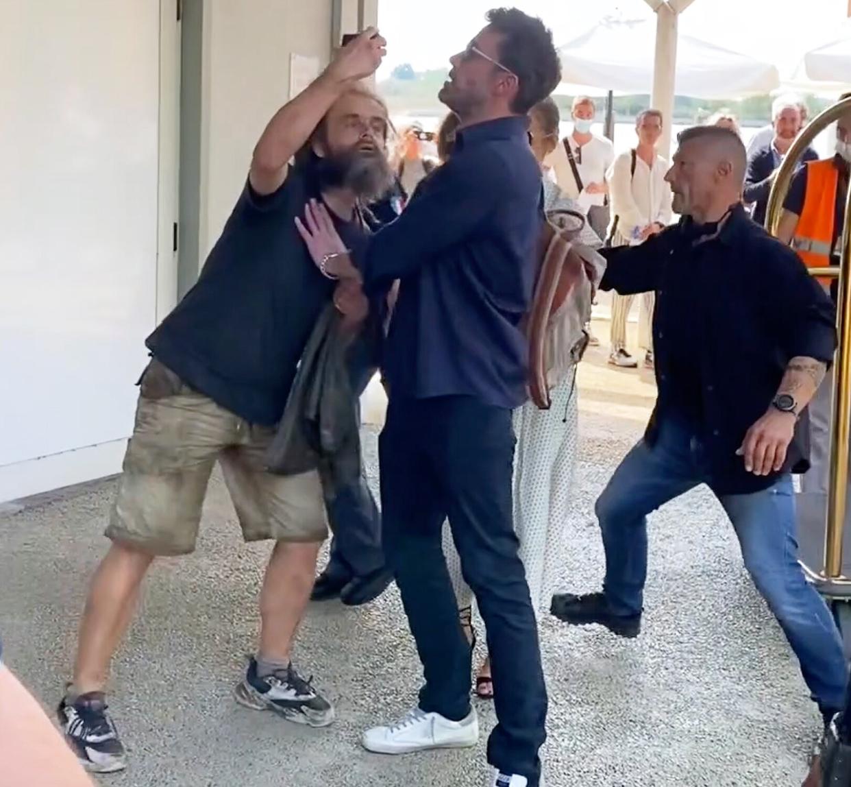 09/11/2021 EXCLUSIVE: Ben Affleck pushes away a fan who tries to take a photo with Jlo in Venice. The 49 year old American actor who is attending the Venice film festival with Lopez was spotted pushing away a male at an airport as a fan attempted to take a selfie with the couple.