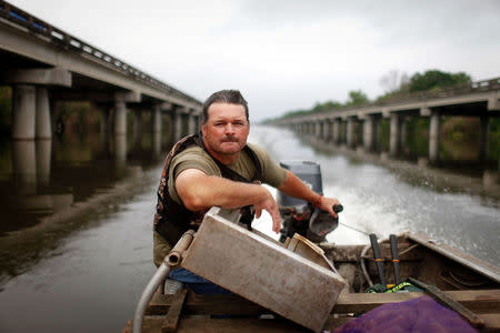 FILE PHOTO - Crawfisherman Jody Meche looks over rising waters in the Atchafalaya Basin near Butte LaRose, Louisiana, U.S. May 20, 2011. REUTERS/Lee Celano/File Photo