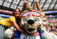 <p>A football fan with a costumed character of the official Russia 2018 mascot, Zabivaka the Wolf, during a First Stage Group C football match between Denmark and France at Luzhniki Stadium at FIFA World Cup Russia 2018; the teams drew 0-0. Sergei Bobylev/TASS (Photo by Sergei Bobylev\TASS via Getty Images) </p>