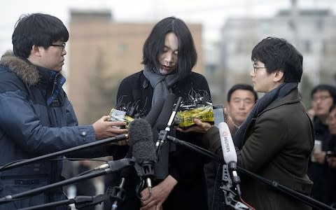 Cho Hyun-ah, daughter of Korean Air Lines chairman, when she appears in front of the media outside the offices of the Aviation and Railway Accident Investigation Board in Seoul - Credit: Reuters