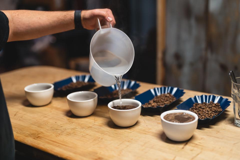 Empire Tea & Coffee owner CJ Barone prepares tp check the flavor of a roast — a process called “cupping.”
