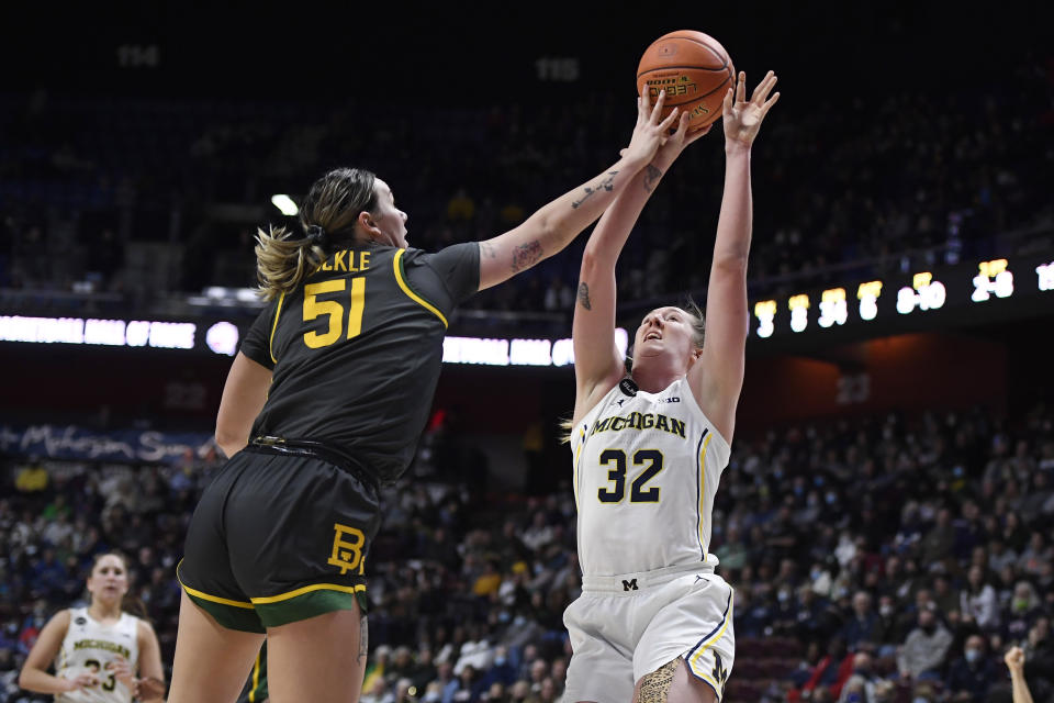 Baylor's Caitlin Bickle (51) fouls Michigan's Leigha Brown (32) in the second half of an NCAA college basketball game, Sunday, Dec. 19, 2021, in Uncasville, Conn. (AP Photo/Jessica Hill)