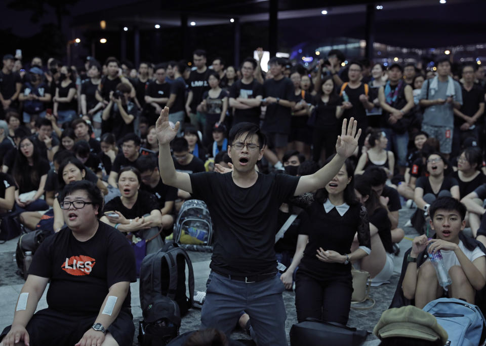 Protesters sing after a march against an extradition bill outside Legislative Council in Hong Kong on Sunday, June 16, 2019. Hong Kong residents Sunday continued their massive protest over an unpopular extradition bill that has highlighted the territory's apprehension about relations with mainland China, a week after the crisis brought as many as 1 million into the streets. (AP Photo/Vincent Yu)