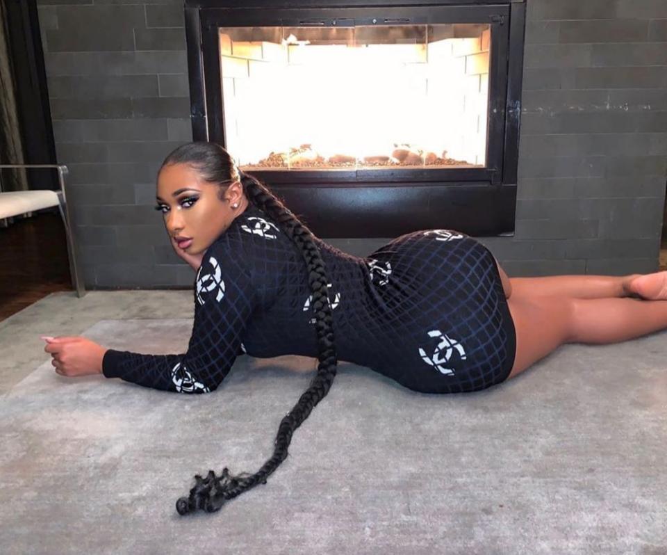 Megan Thee Stallion lies on the floor in a dress