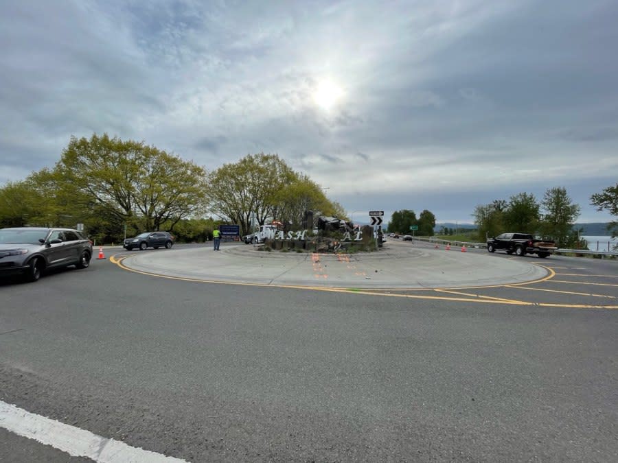 A car left a Washougal, WA roundabout crashing through a sign and landing on its side (KOIN)