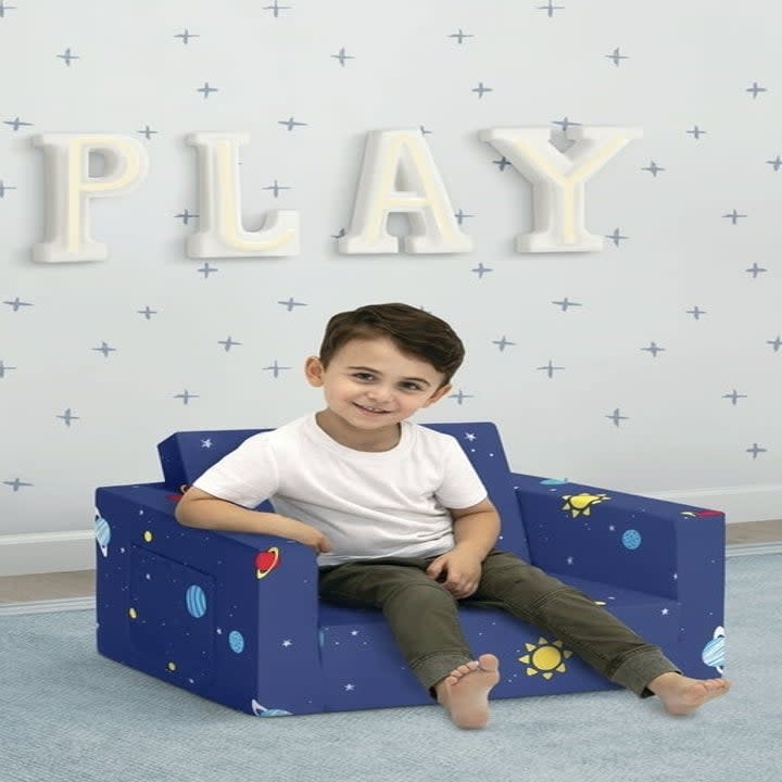 Child sits in a chair