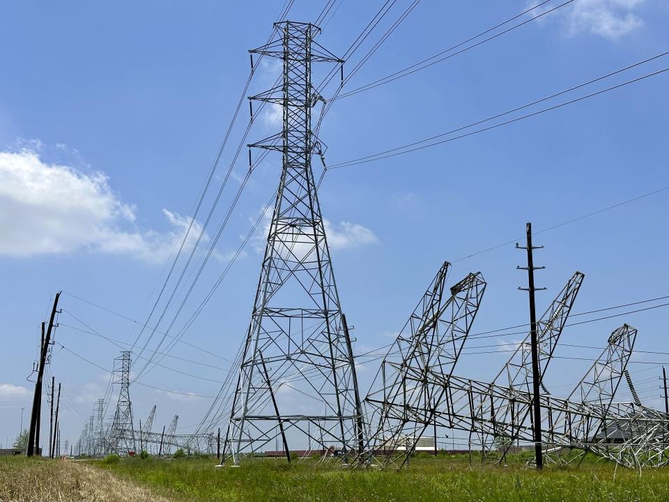 Power transmission lines were twisted and toppled after powerful storms swept through the Houston area on Saturday, May 18, 2024 in Cypress, Texas. As the Houston area works to clean up and restore power to hundreds of thousands, it will do so amid a smog warning and rising Texas heat. (AP photo/Mark Vancleave)