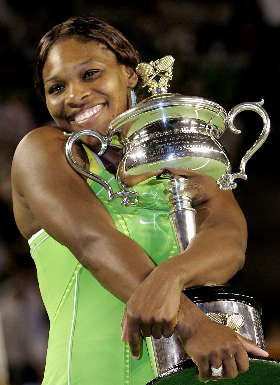 FILE - Serena Williams hugs the Australian Open trophy after defeating Maria Sharapova of Russia in their women's singles final match at the Australian Open tennis tournament in Melbourne, Australia, Saturday, Jan. 27, 2007. Williams won the final, 6-1 6-2. The 2022 Wimbledon competition is not the first comeback from a significant absence for Williams. (AP Photo/Rick Stevens, File)