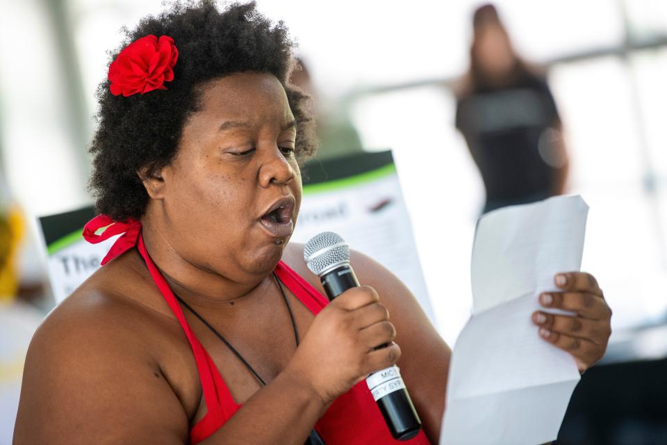 Madison Clark reads a poem during the Juneteenth Celebration at Switchyard Park where a new historical marker memorializing Bloomington's Black Underground Railroad conductors was revealed Saturday.