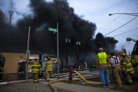 New Jersey firefighters look at rising smoke as they work to control a massive fire in Seaside Park in New Jersey September 12, 2013. The fast-moving fire that started in a custard shop raged through several blocks of boardwalk and businesses on Thursday in Seaside Park, a shore town that was still rebuilding from damage caused by Superstorm Sandy. (REUTERS/Eduardo Munoz)