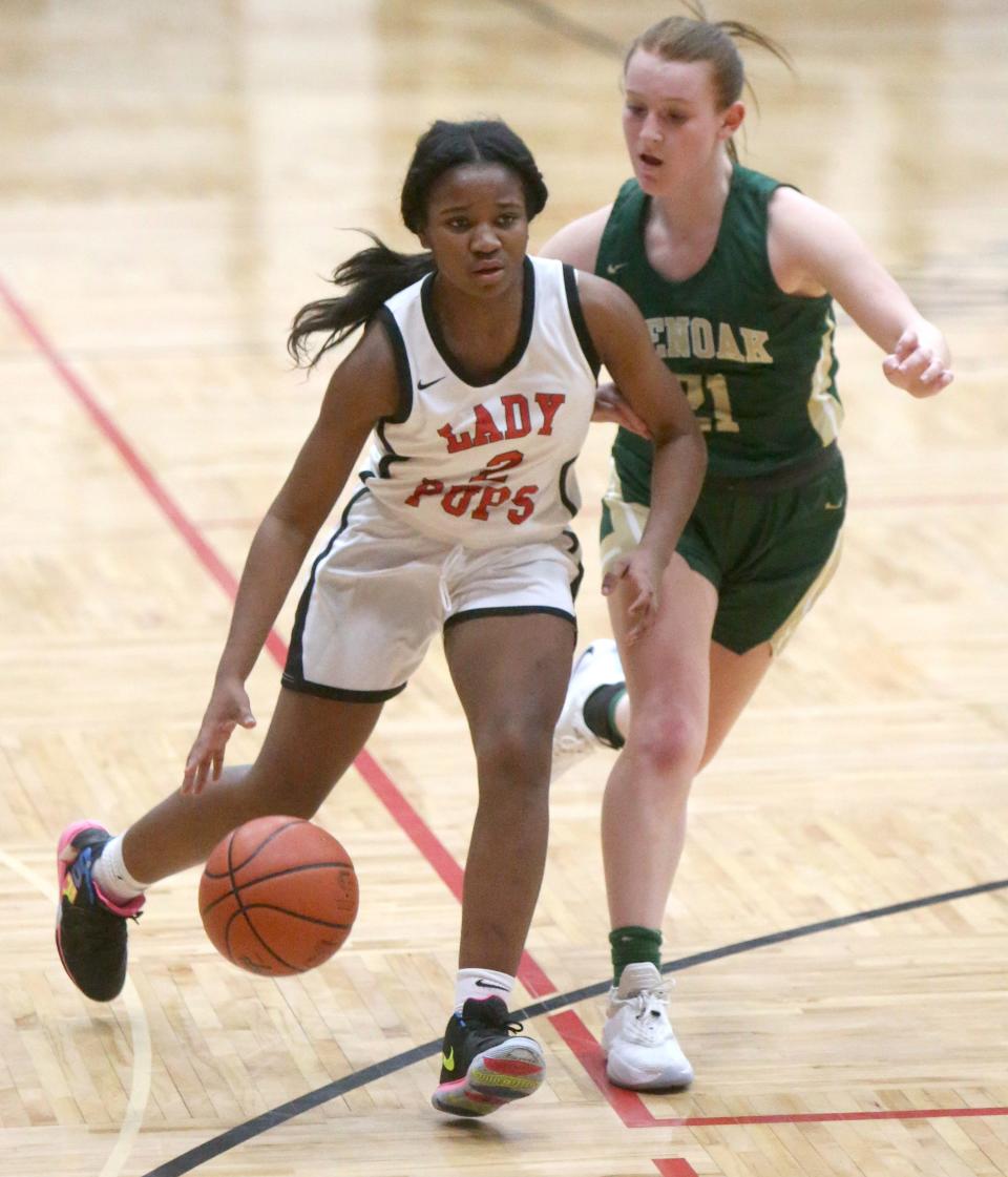 Paris Stokes (2) of McKinley brings the ball upcourt while being guarded by Keely Burke (21) during their game at McKinley on Wednesday, Jan. 13, 2021.