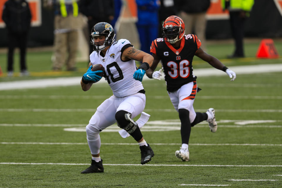 Jacksonville Jaguars tight end James O'Shaughnessy (80) runs after a catch in front of Cincinnati Bengals strong safety Shawn Williams (36) in the second half of an NFL football game in Cincinnati, Sunday, Oct. 4, 2020. (AP Photo/Aaron Doster)