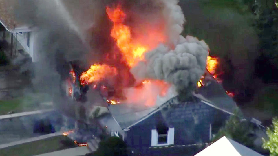 FILE-- In this Sept. 13, 2018 file image taken from video provided by WCVB in Boston, flames consume a home of Lawrence, Mass. police officer Ivan Soto in Lawrence, Mass, a suburb of Boston. Officials announced that most have been connected back to their service following the fires, explosions and loss of their main heating utility, but there are many issues which still need to be solved. (WCVB via AP)