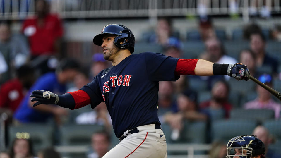 Boston Red Sox's J.D. Martinez follows through on a triple during the third inning of the team's baseball game against the Atlanta Braves on Tuesday, June 15, 2021, in Atlanta. (AP Photo/John Bazemore)