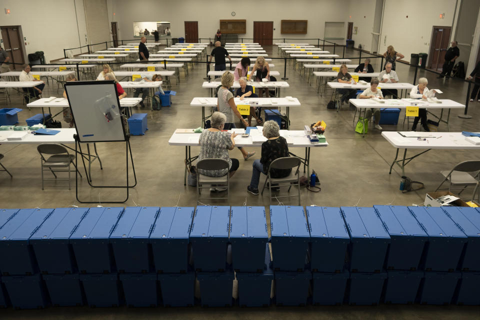 Bipartisan counting teams prepare to recount nearly 150,000 ballots in Wichita, Kansas, on Wednesday, Aug. 17, 2022 on a constitutional amendment that would've removed abortion rights from the Kansas Constitution. Nine of the state's 105 counties were forced to do the recount by two Republican activists. Voters earlier this month rejected a proposed amendment to the Kansas Constitution that would have allowed the Republican-controlled Legislature to further restrict abortion or ban it. (Jaime Green/The Wichita Eagle via AP)