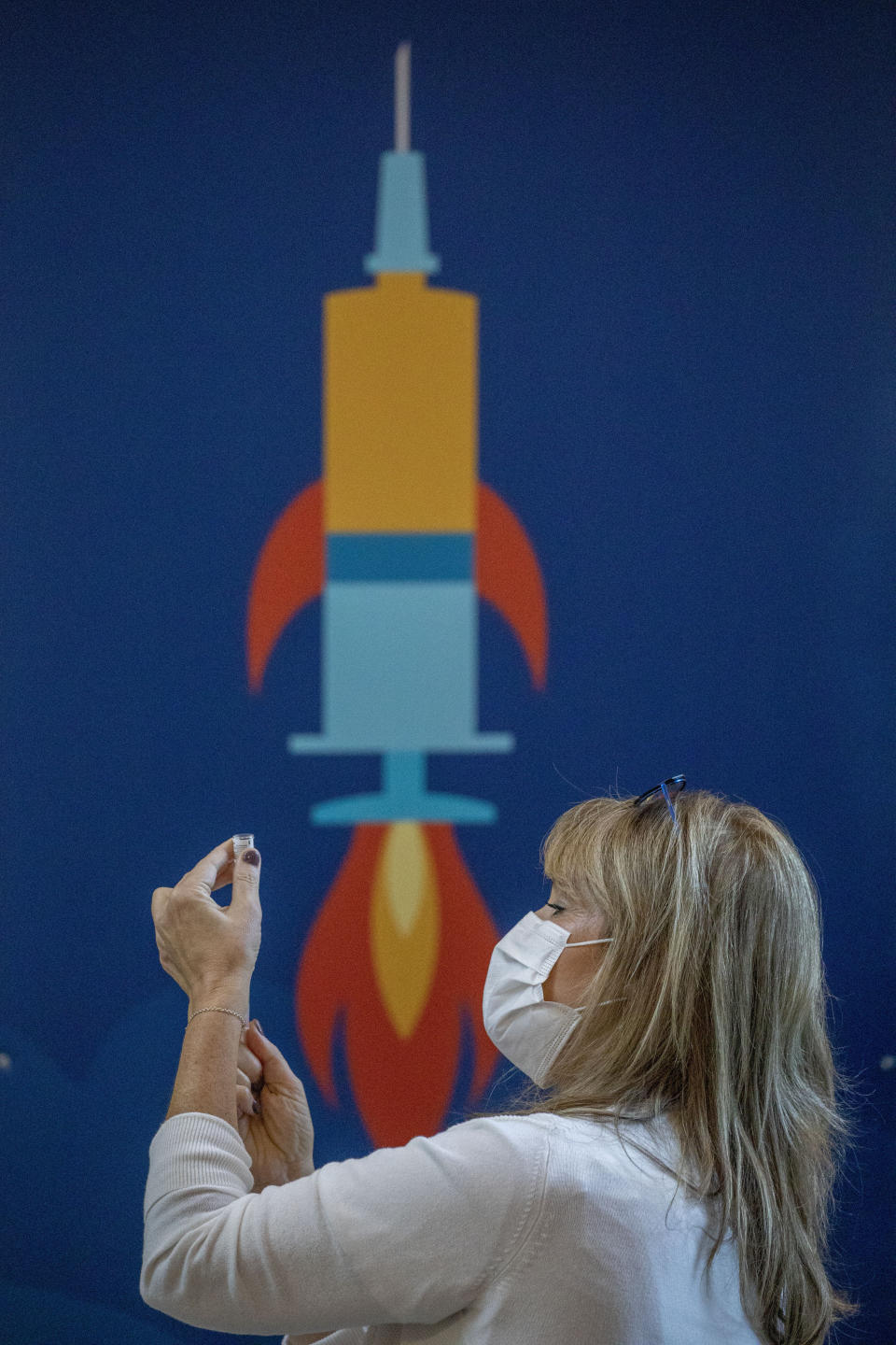 A medical staff member prepares a COVID-19 coronavirus vaccine at the Ichilov Hospital in Tel Aviv, Israel, Sunday, Dec. 20, 2020. (AP Photo/Ariel Schalit)