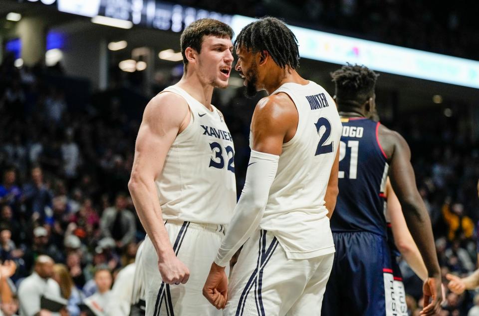 Xavier Musketeers forward Zach Freemantle (32) and  Jerome Hunter (2) celebrate after Hunter is fouled by the Connecticut Huskies Saturday, December 31, 2022 at the Cintas Center. The Musketeers upset the Huskies 83-73.