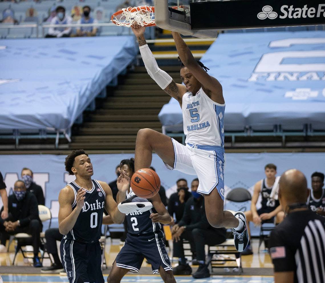 North Carolina’s Armando Bacot (5) dunks over Duke’s Wendell Moore Jr. (0) during the first half against on Saturday, March 6, 2021 at the Smith Center in Chapel Hill, N.C.