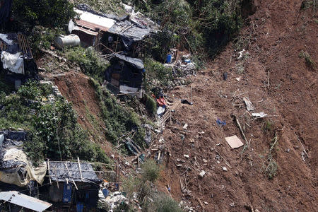 A view of debris and destroyed houses at the site of a landslide, after super typhoon Mangkhut hit the country, at a mining camp in Itogon, Benguet, Philippines September 17, 2018. REUTERS/Erik De Castro