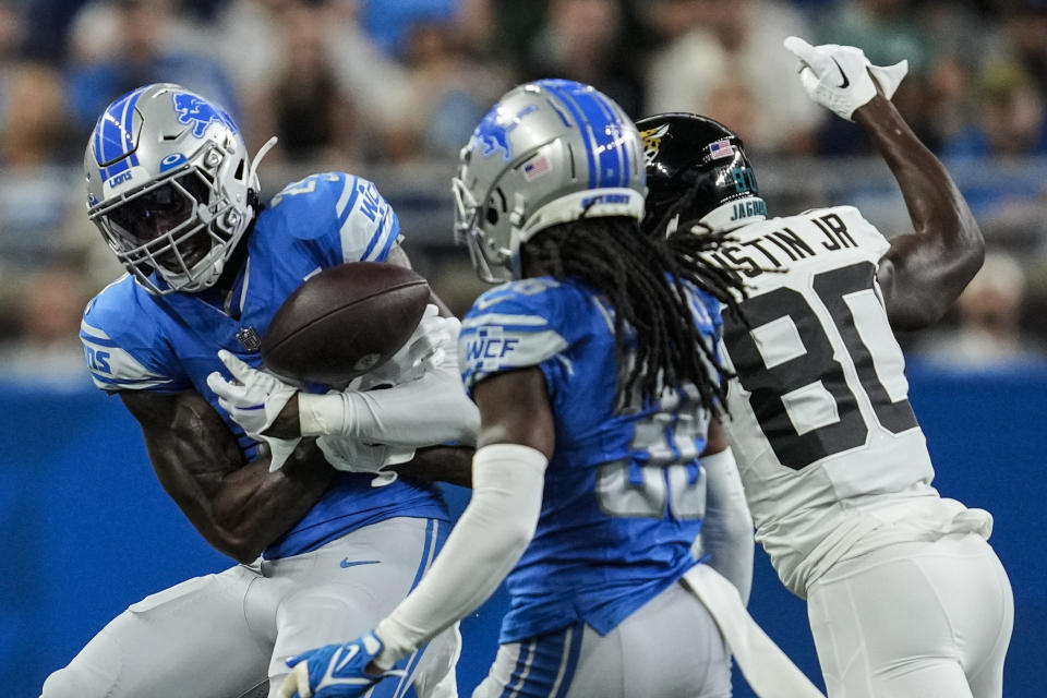 Detroit Lions cornerback Steven Gilmore (36) intercepts a pass intended for Jacksonville Jaguars wide receiver Kevin Austin Jr. (80) during the first half of a preseason NFL football game, Saturday, Aug. 19, 2023, in Detroit. (AP Photo/Paul Sancya)