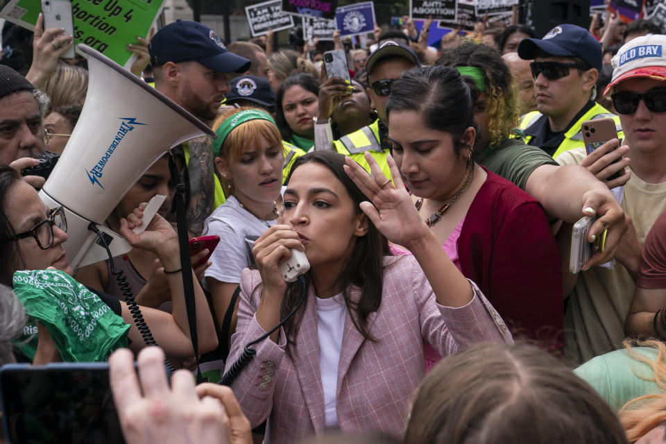 Rep. Alexandria Ocasio-Cortez stands in a crowd of abortion rights activists. 