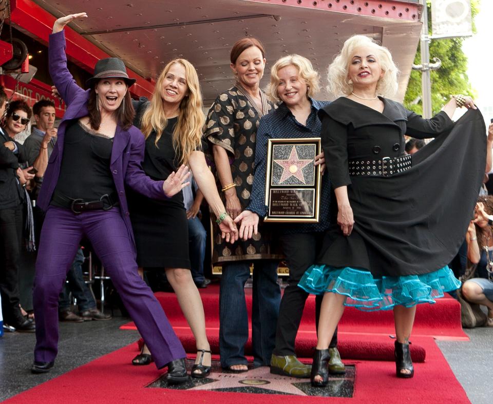 The Go-Go's, from left, Kathy Valentine, Charlotte Caffey, Belinda Carlisle, Gina Schock and Jane Wiedlin, are honored with a star on the Hollywood Walk of Fame Thursday, Aug. 11, 2011, in Los Angeles. (AP Photo/Damian Dovarganes)