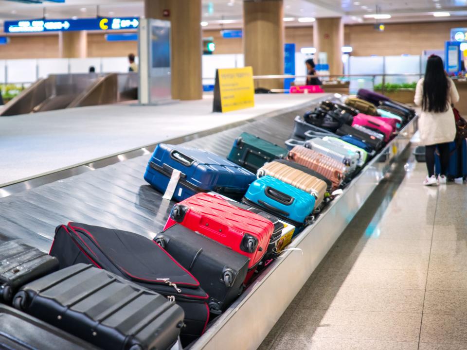 Woman walking away from baggage claim.