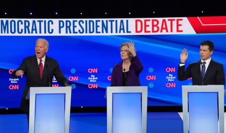 Democratic presidential candidate former Vice Presiden Biden speaks as Sen. Warren and South Bend Mayor Pete Buttigieg raise their hands to speak during the fourth U.S. Democratic presidential candidates 2020 election debate in Westerville, Ohio