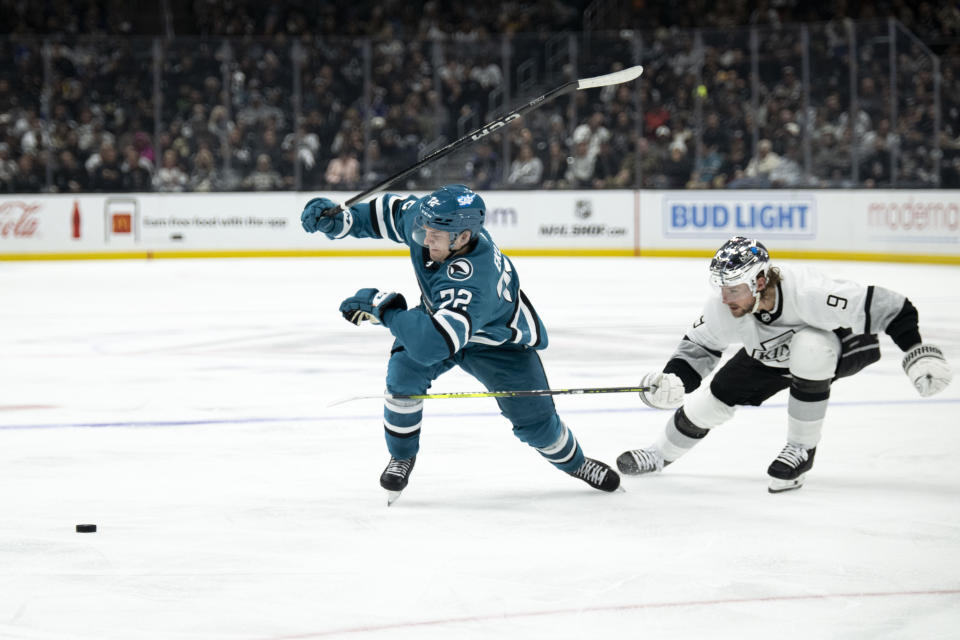 San Jose Sharks center Ryan Carpenter (22) watches the puck as Los Angeles Kings right wing Adrian Kempe (9) chases during the third period of an NHL hockey game Wednesday, Dec. 27, 2023, in Los Angeles. (AP Photo/Kyusung Gong)