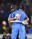 India's Rohit Sharma celebrates with KL Rahul after hitting the winning runs in the super over to win the Twenty/20 cricket international between India and New Zealand in Hamilton, New Zealand, Wednesday, Jan. 29, 2020. (Andrew Cornaga/Photosport via AP)