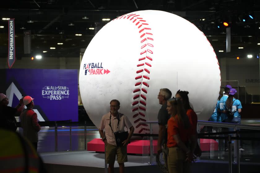 The worlds largest baseball sits on exhibit during a media tour at the Play Ball Park exhibit at the Colorado Convention Center staged by Major League Baseball as part of the festivities leading up to the All Star Game Thursday, July 8, 2021, in Denver. The convention center has been turned into a paradise for baseball aficionados complete with batting cages, an onsite home run derby, items from the Hall of Fame and countless merchandise for sale for baseball fans from far and near at the store. (AP Photo/David Zalubowski)