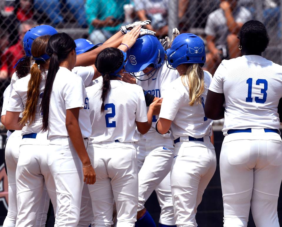 Stamford’s Emma Follis is congratulated by teammates after her late-game three-run home run against Colorado City Saturday.