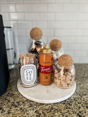 A set of three glass jars with cork tops