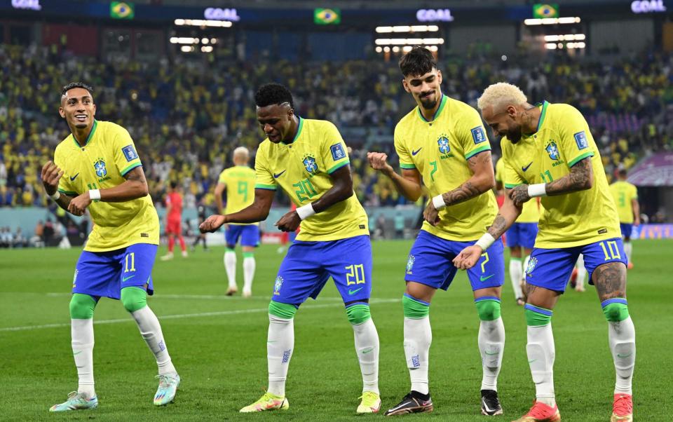 Brazil's forward #20 Vinicius Junior (2ndl) celebrates scoring his team's first goal with Brazil's forward #11 Raphinha, Brazil's midfielder #07 Lucas Paqueta and Brazil's forward #10 Neymar - AFP/Getty