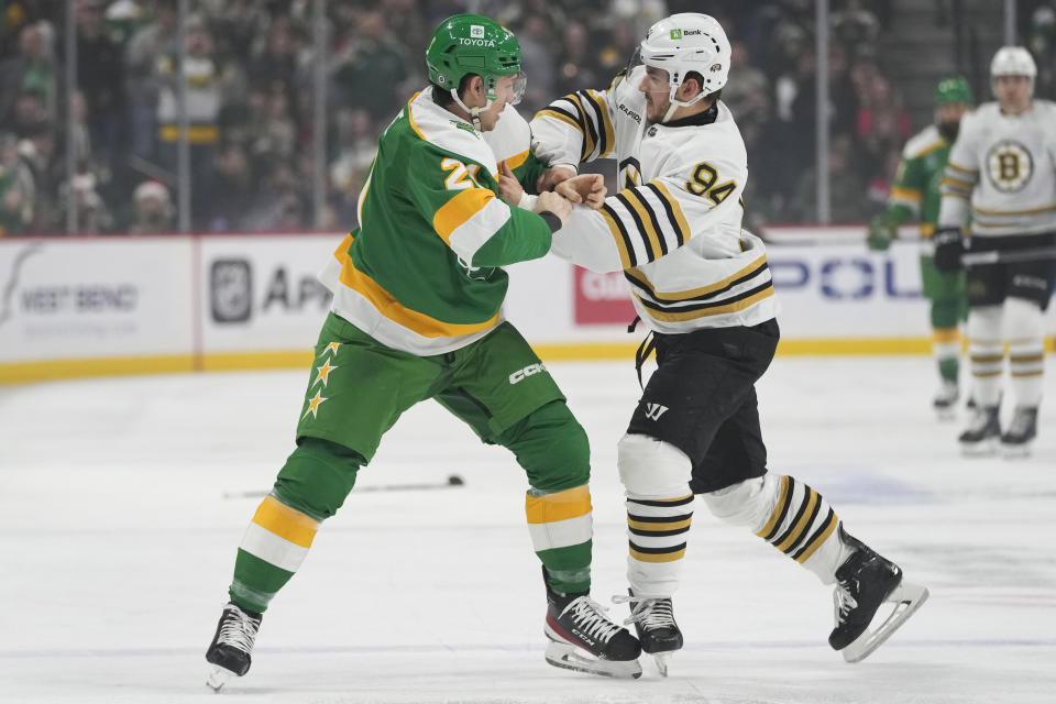 Minnesota Wild right wing Brandon Duhaime, left, and Boston Bruins center Jakub Lauko (94) fight during the first period of an NHL hockey game Saturday, Dec. 23, 2023, in St. Paul, Minn. (AP Photo/Abbie Parr)